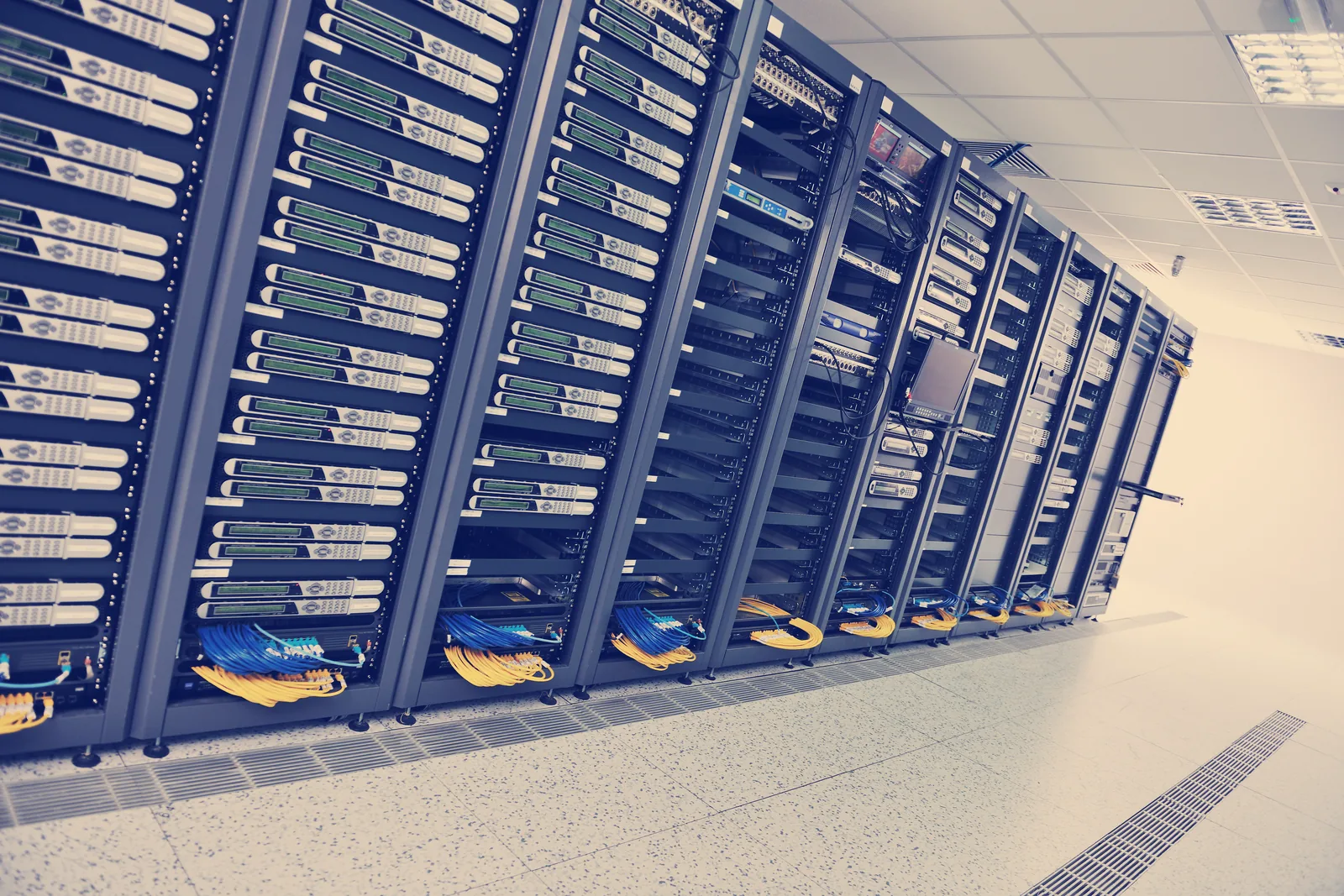 Rows of enterprise servers with structured cabling in a modern data centre