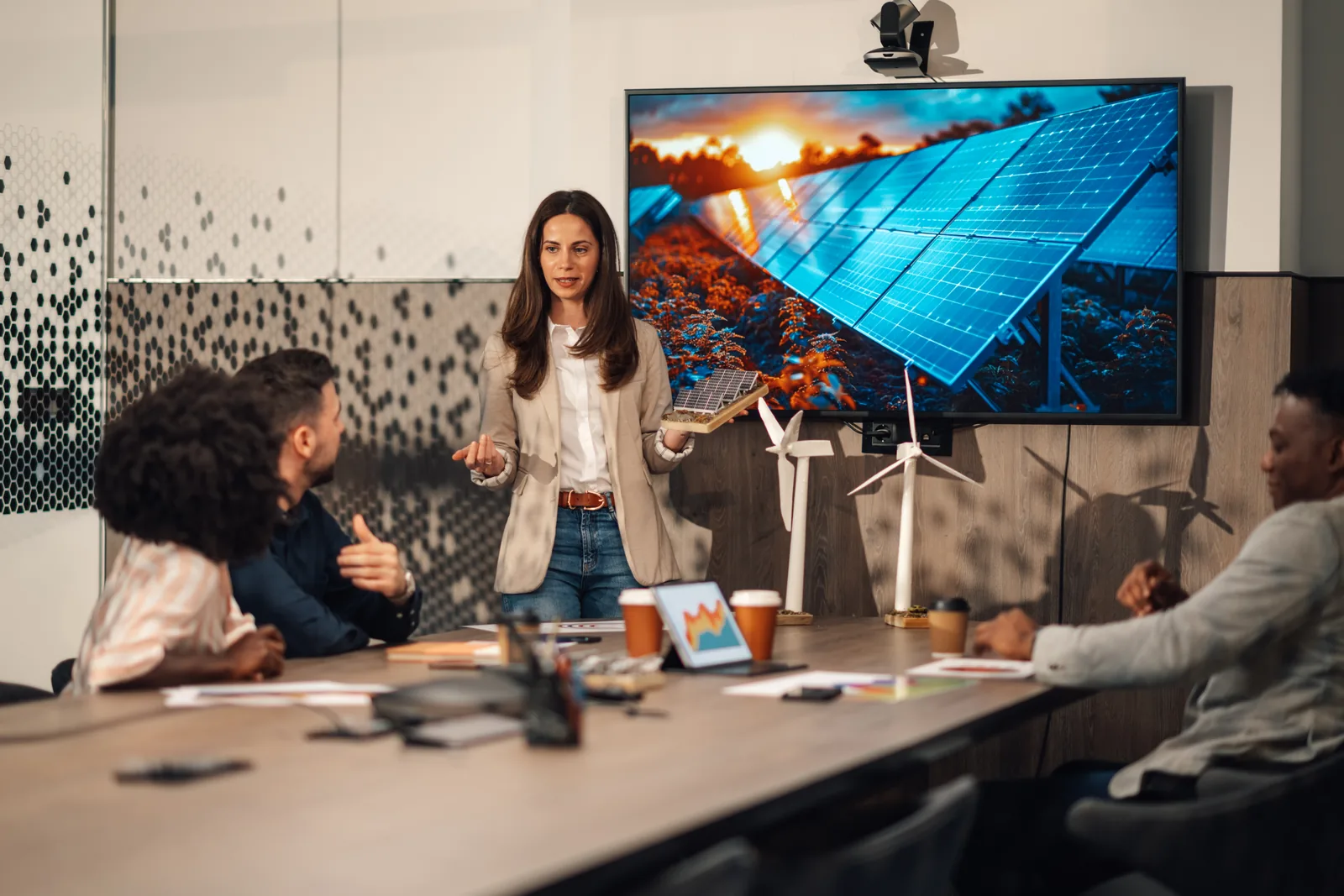 Team collaborating in a boardroom equipped with video conferencing