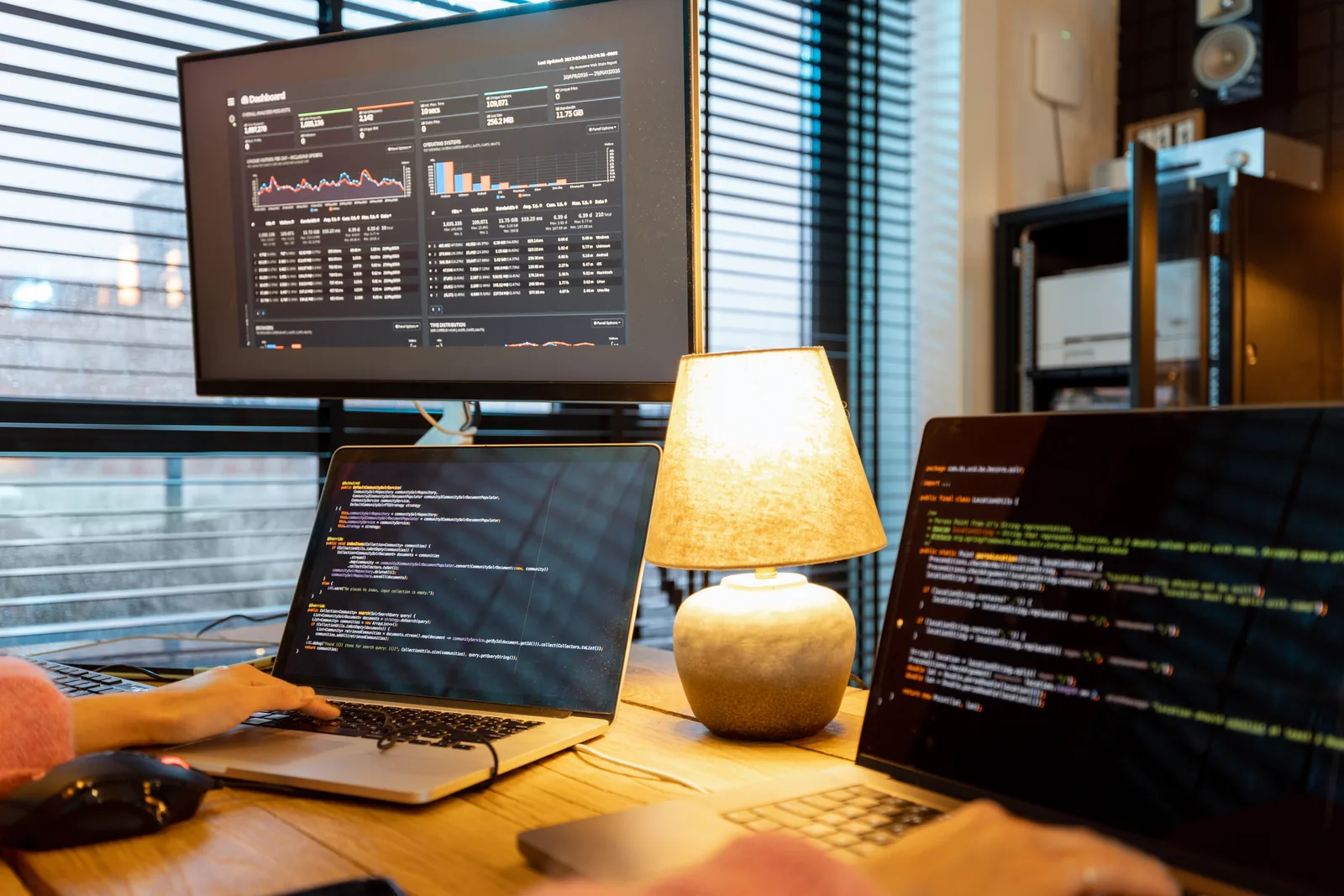 Software developer writing application code on a widescreen display